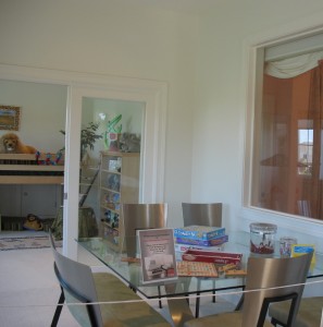 A window from the children's lounge area that looks into a little girl's room.