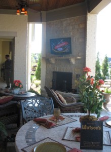 Step out of the master bedroom onto a covered porch that features a firelace and plenty of seating.