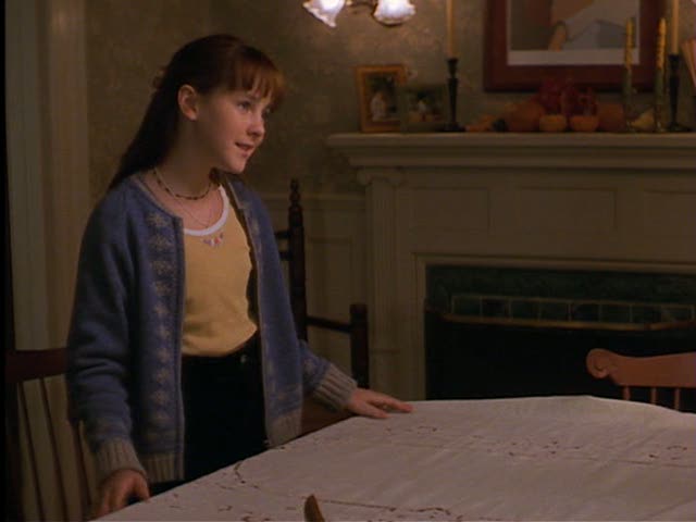 dinrm2 Anna helps her mom set the table in the dining room. In this shot you can see they have a fireplace in the room.