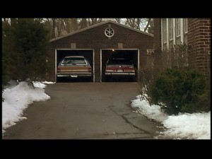 Detached garage behind the house. Kevin's parents forgot to close the garage doors, so at first Kevin thinks they're still home.