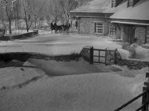 Elizabeth is engaged to an architect, and this is his Connecticut farmhouse. They're arriving by horse and sleigh because...well, because it's a lot more romantic than driving up in a car, I suppose.