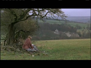Jane sits on a hill, sketching Thornfield in the distance.