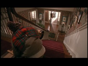 Kevin decides to take a sled ride down the stairs.