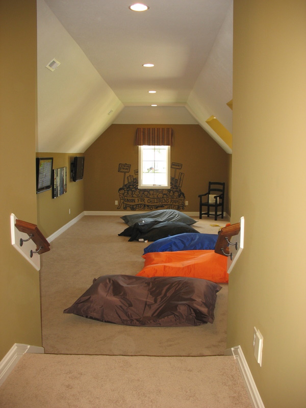 The huge playroom over the garage featured a wall lined with flat-screen TVs to play videogames on.