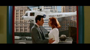 It's Vegas or Bust. Roll credits as they ride the helicopter ladder--yes, they hang onto the ladder--over New York City, circa 1960.