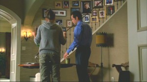 The front hall with a curving staircase that features lots of family photos. In one episode, Nora hangs a family photo that doesn't include daughter Kitty, and it causes all sorts of friction.
