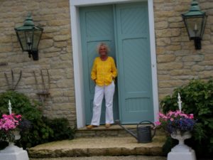Suzy Stout at her Illinois farmhouse-turquoise front doors