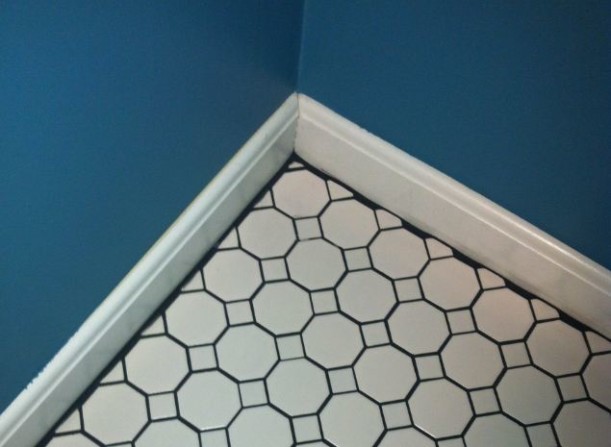 black grout around edge of room