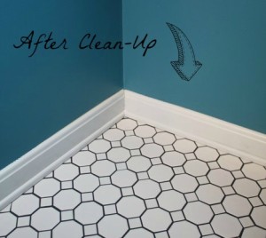 black grout in bath covered by trim after clean-up