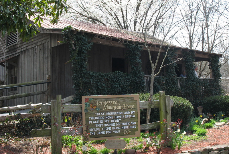 sign in front of cabin which is a replica of Dolly Parton\'s childhood home