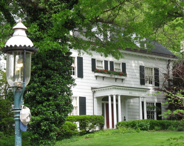 white house with shutters and flower boxes