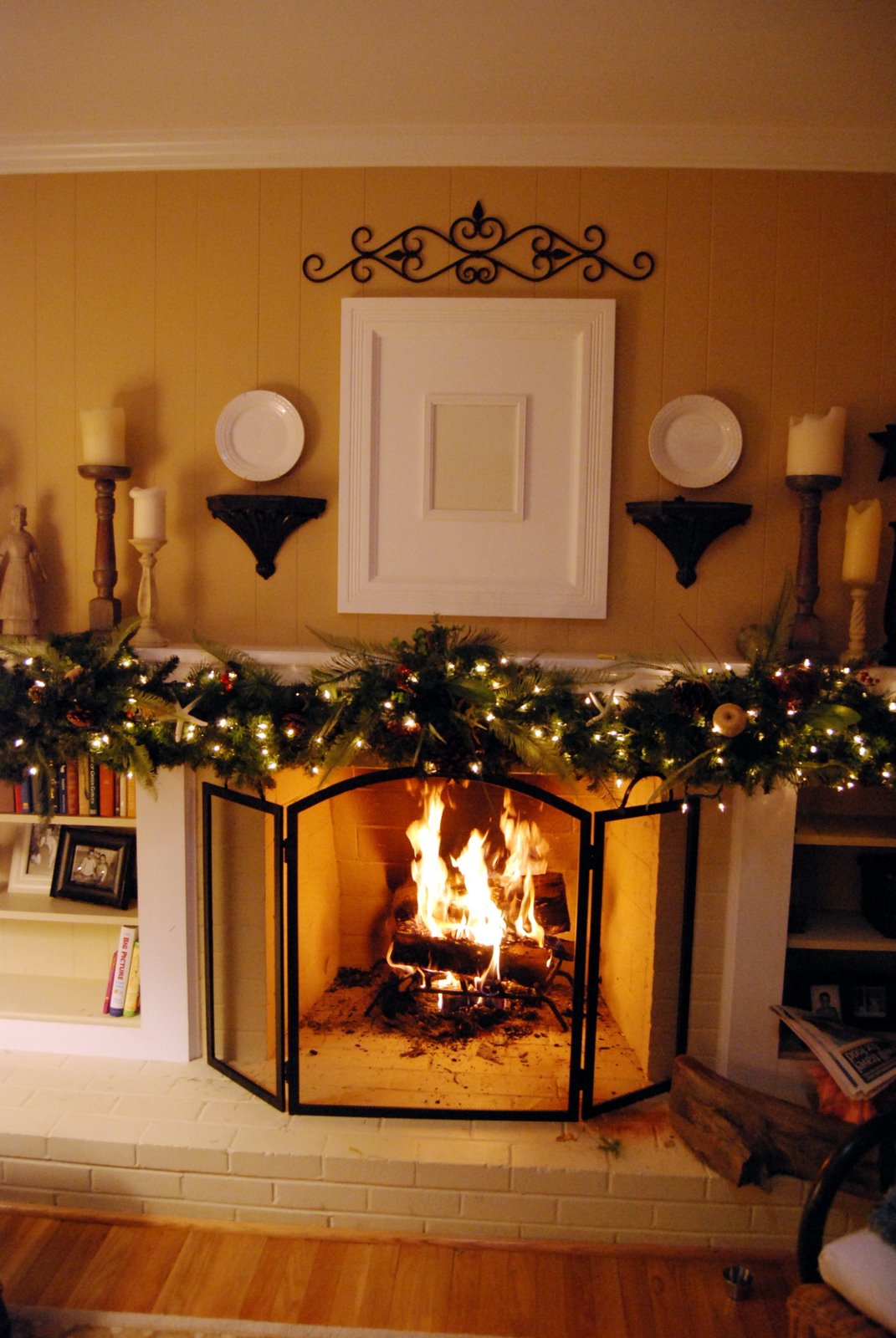 a fireplace with garland on mantel