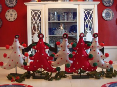 A group of stuffed christmas trees on dining table