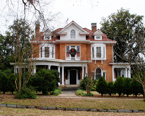 A large brick house with wreath over front door