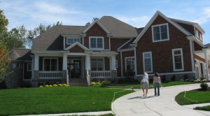 front exterior of shingle style house in home show