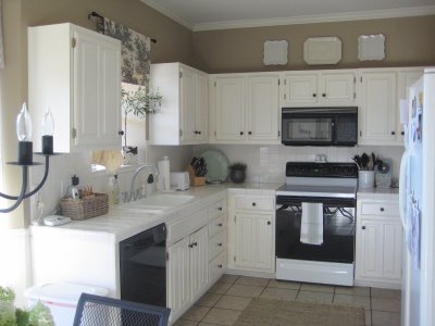 A kitchen with a sink and a microwave