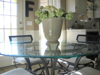 A glass dining room table with vase