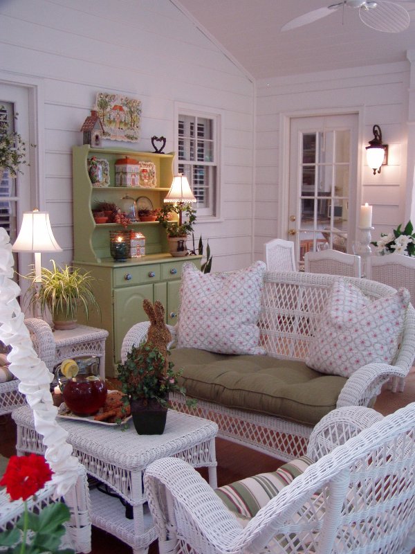 screened porch with white wicker furniture