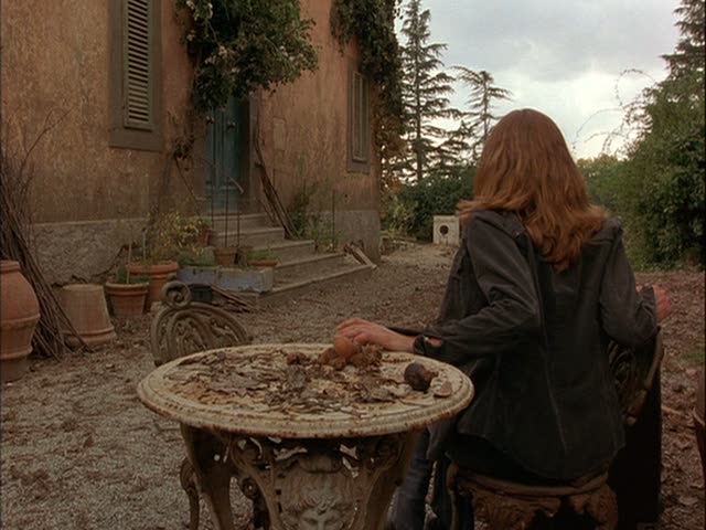 Diane Lane sitting outside the villa surveying the work to be done