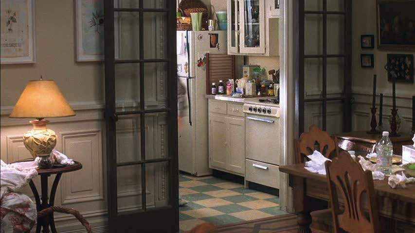 A room filled with furniture and vase on a table