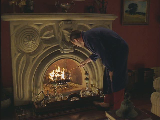 A man standing in front of a fireplace in Stuart Little