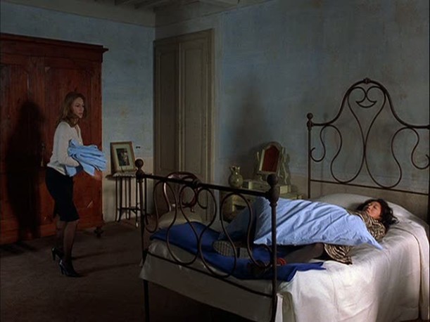 Sandra Oh in blue bedroom