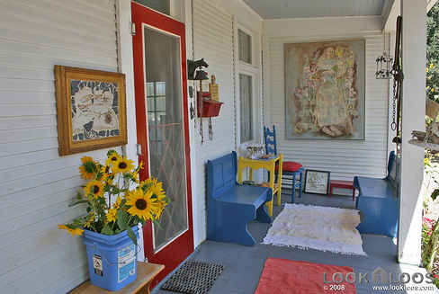 red front door of white farmhouse