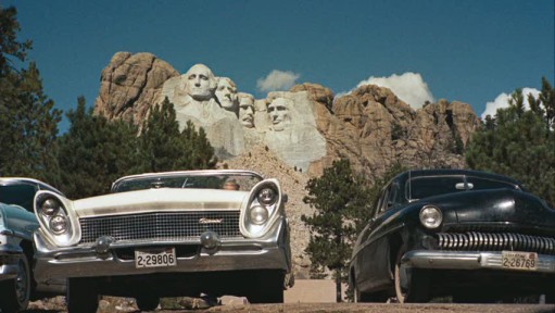 cars parked in lot below Mount Rushmore 