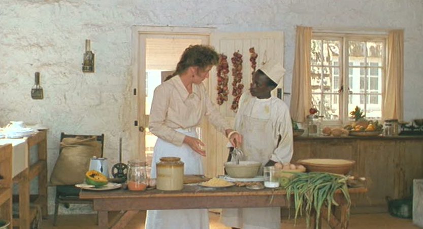 Karen Blixen in the kitchen with a worker