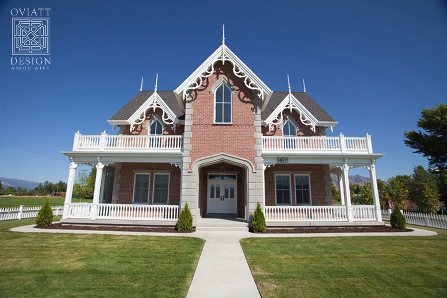 front exterior of red brick Gothic Revival style house built to look old