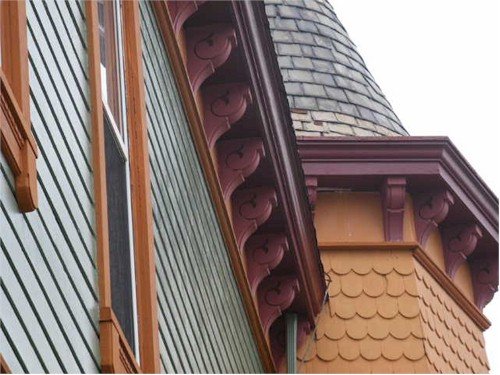 closeup of roofline with hand cut corbels on Victorian house