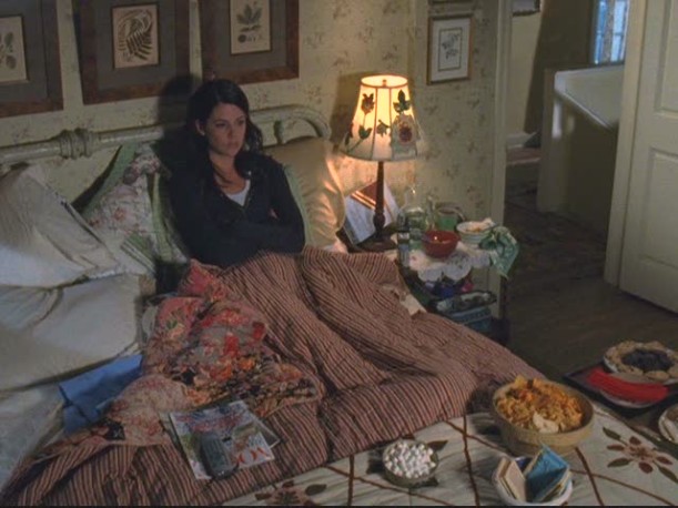 Lorelai sitting in her bed