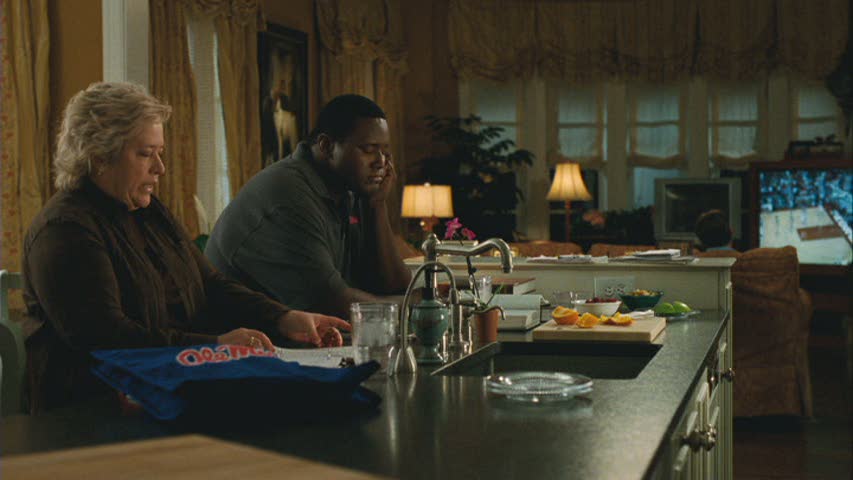 characters sitting at kitchen island at night with lights on