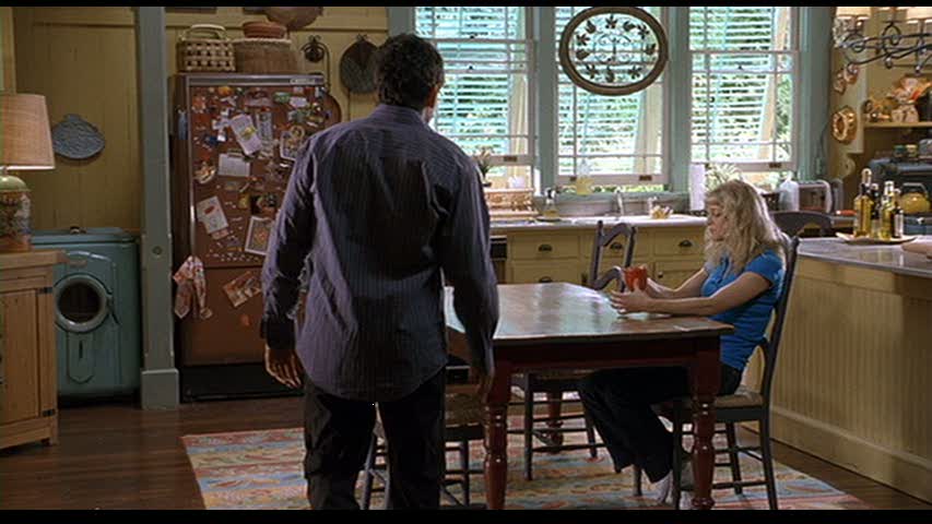 A man and a woman standing in front of a table, with Dustin Hoffman