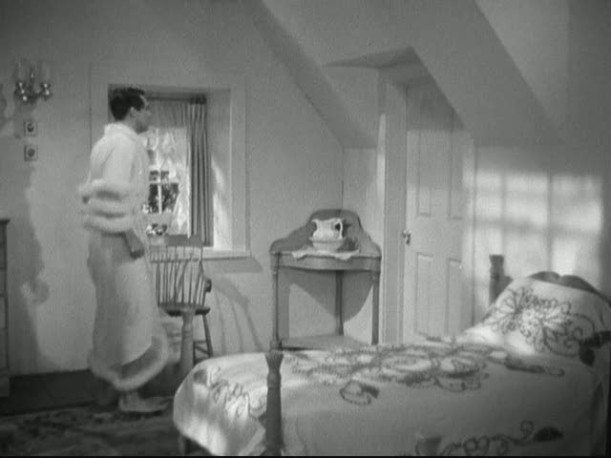 Cary Grant in dressing gown in bedroom