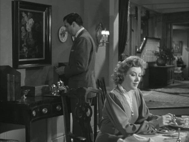 Greer Garson sitting in dining room