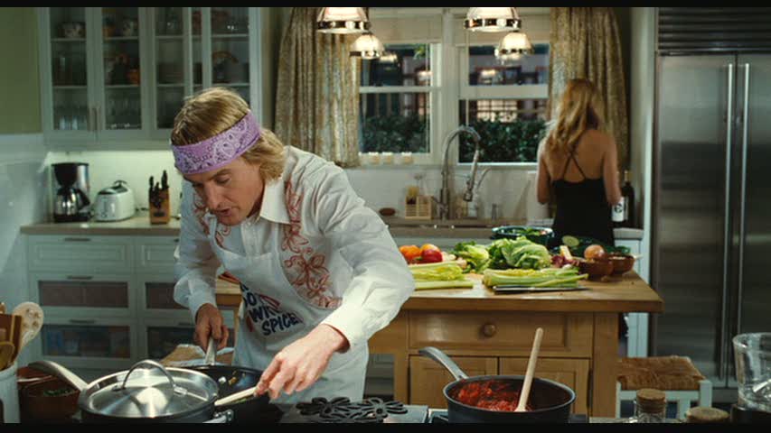 Owen Wilson cooking in kitchen