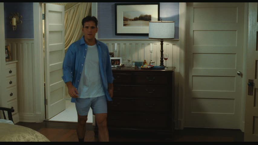 Matt Dillon standing in front of a door