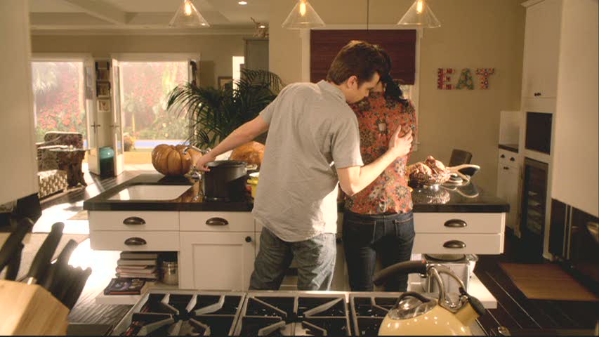 EAT sign - Travis and Jules in kitchen