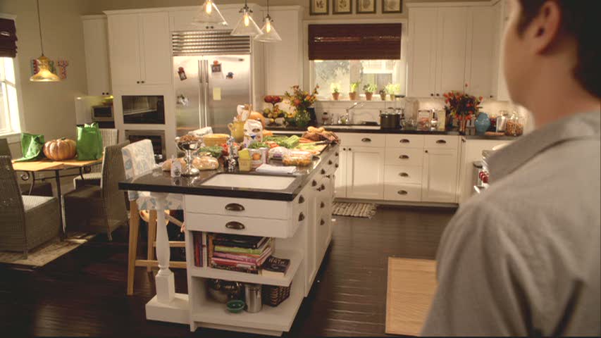 white kitchen with black countertops on Cougar Town