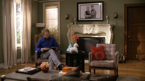 Mitchell reading by his fireplace in Modern Family