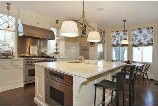 A kitchen with an island in the middle of a room