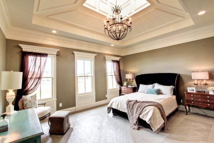 A bedroom with a large bed and skylight