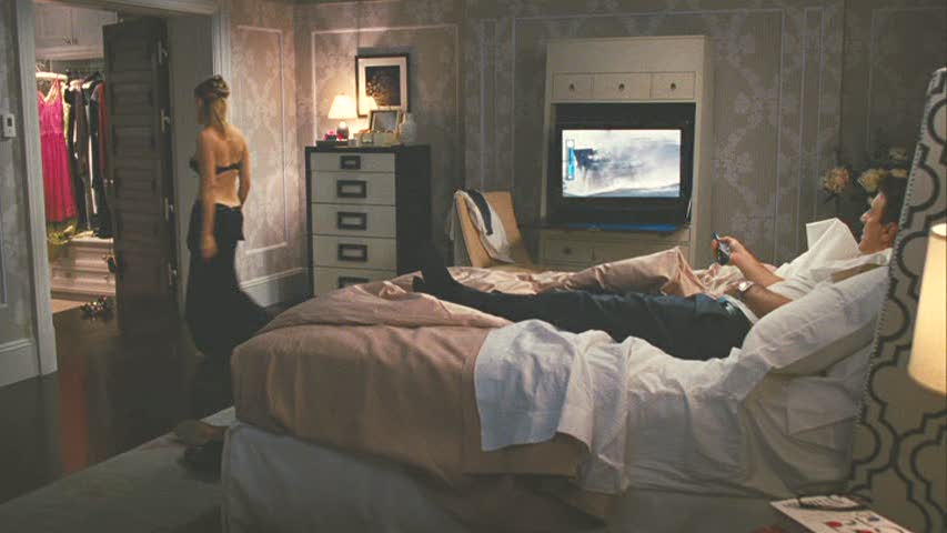 A person sitting on a bed in a room