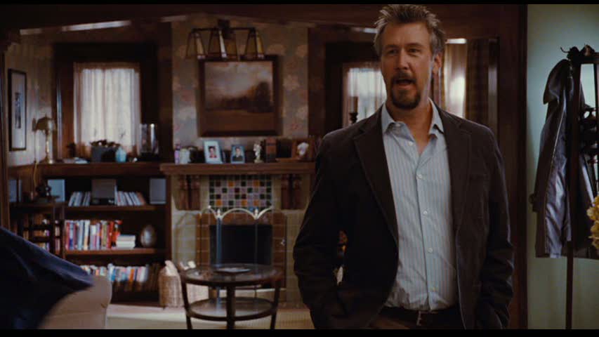 Alan Ruck standing in front of living room fireplace