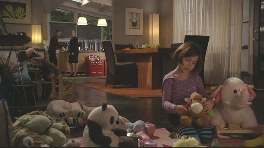 daughter playing with stuffed animals in dining room