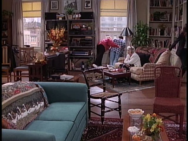 A living room filled with furniture and a large window