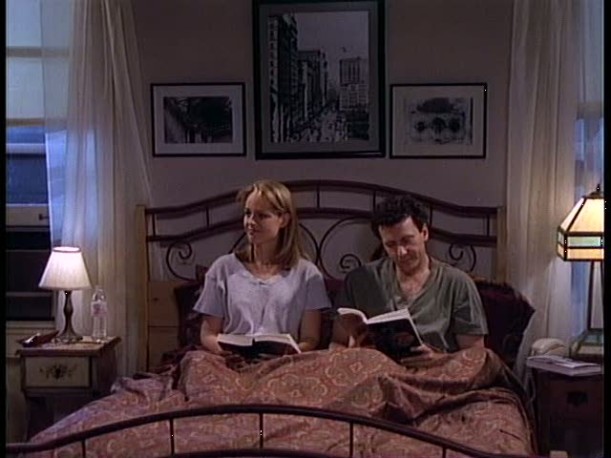 Paul and Jamie sitting in bed reading