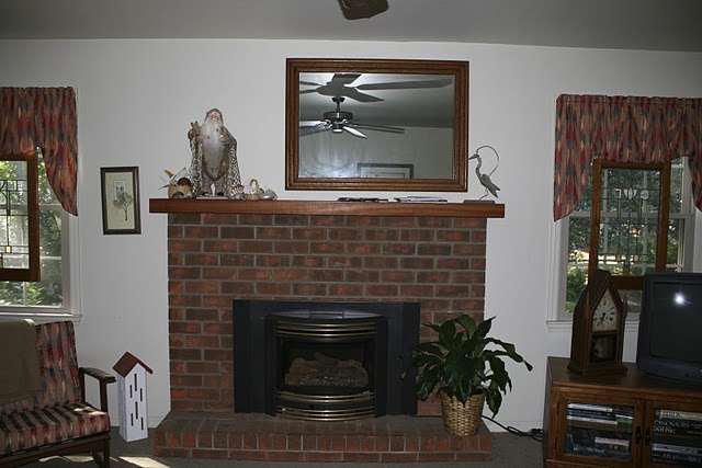 A fireplace in a living room before redecorating