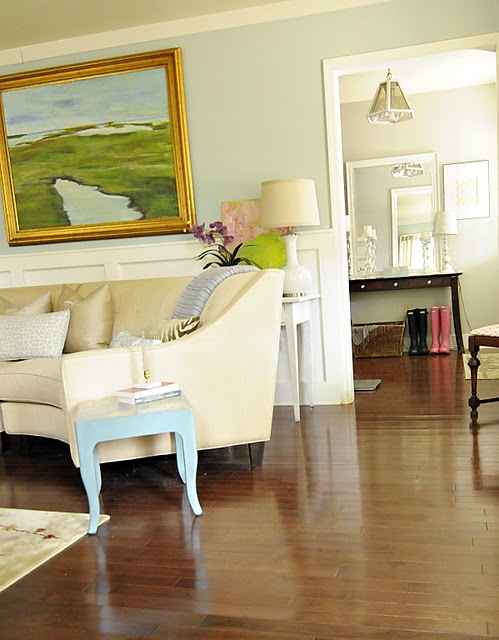 A living room filled with furniture on top of a hard wood floor